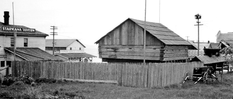 Coupeville block house with canoes and cross