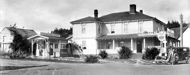 Coupeville block house with canoes and cross