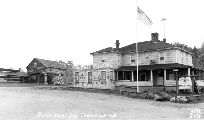 Coupeville block house with canoes and cross